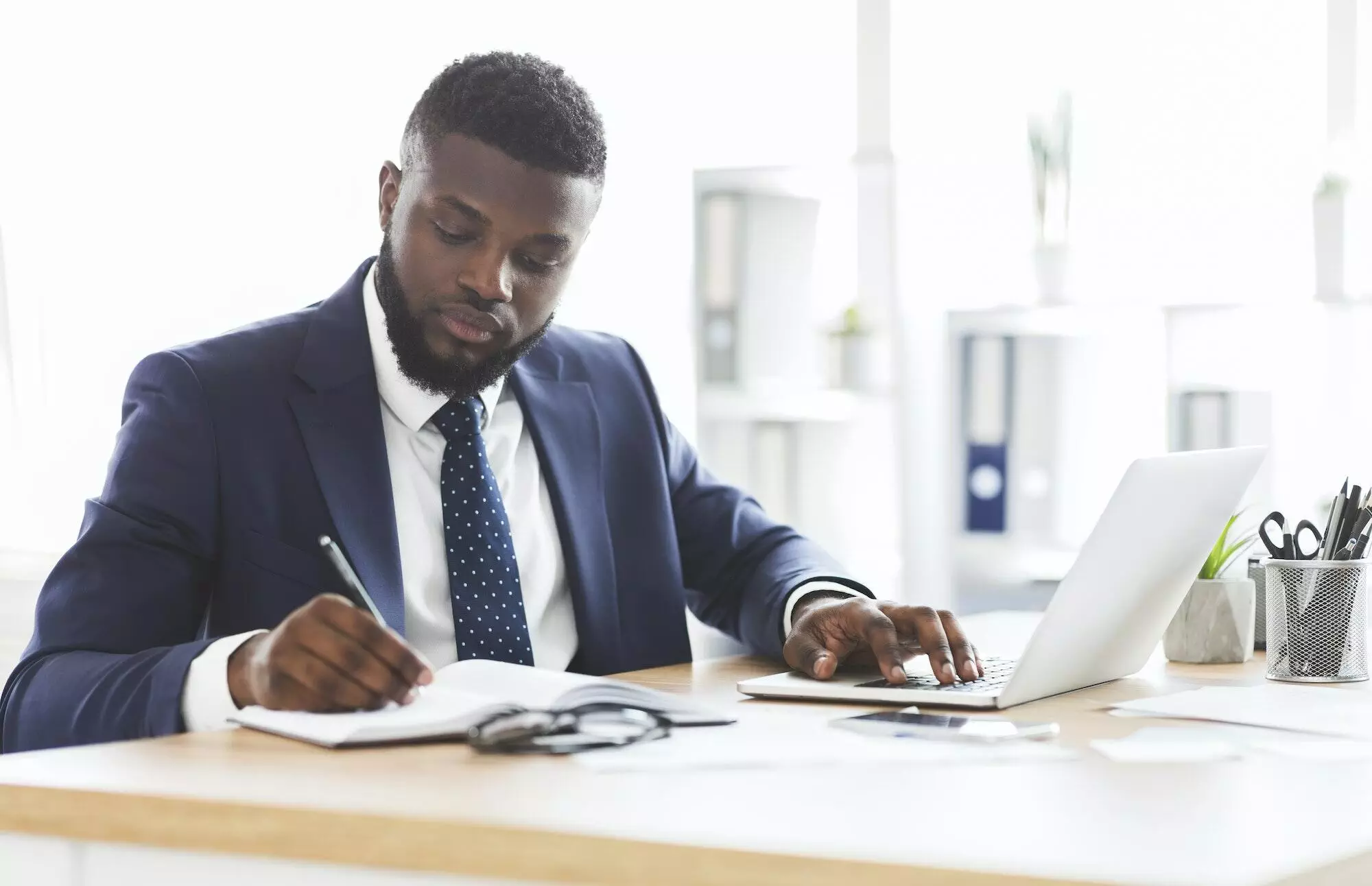 Successful black businessman working hard in office